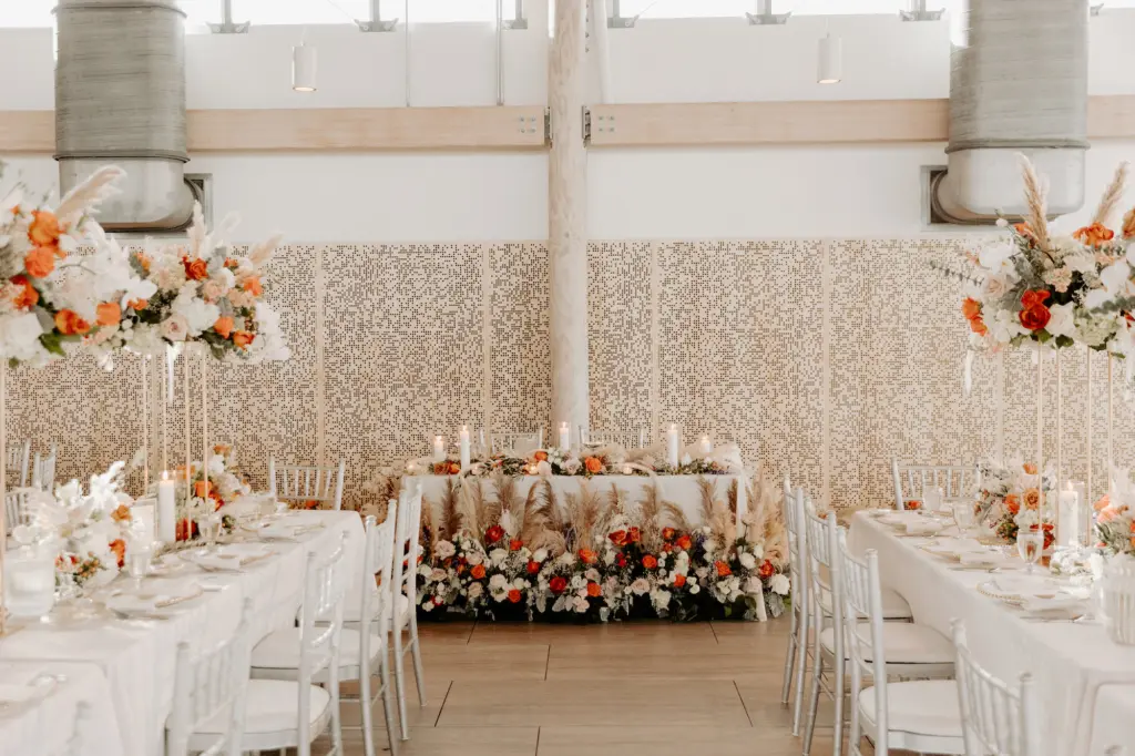 Boho Sweetheart Table for Wedding Reception with Pampas Grass, Orange, Pink, and White Roses, Baby's Breath, and Greenery Floor Flower Arrangement Ideas