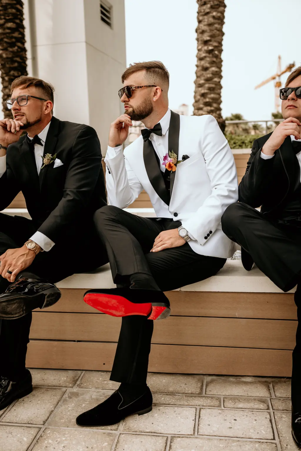 Groom in White Tux and Black Bow Tie and Red Bottom Christian Louboutin Shoes Ideas with Groomsmen in Black Suits