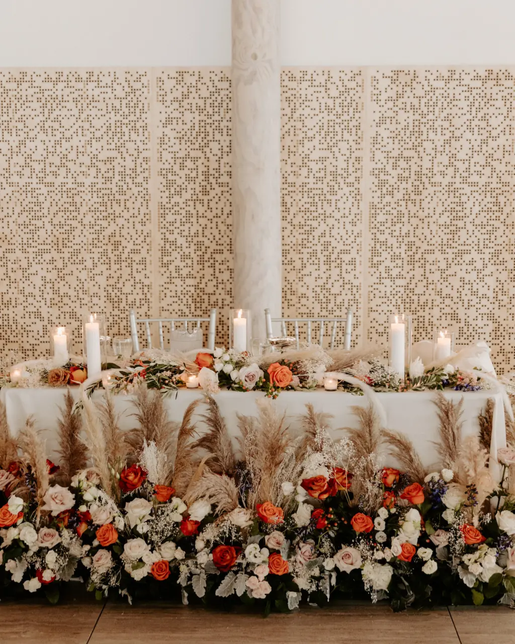 Boho Sweetheart Table for Wedding Reception with Candles, Pampas Grass, Orange, Pink, and White Roses, Baby's Breath, and Greenery Floor Flower Arrangement Ideas