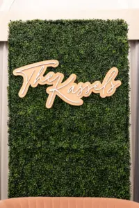 Boxwood Wall Sweetheart Table Backdrop with Last Name Sign | St Pete Rentals Gabro Event Services