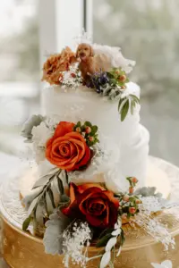 Round Two-tiered Wedding Cake with Orange and White Roses, Dried Flowers, and Greenery with Dog Cake Topper Inspiration