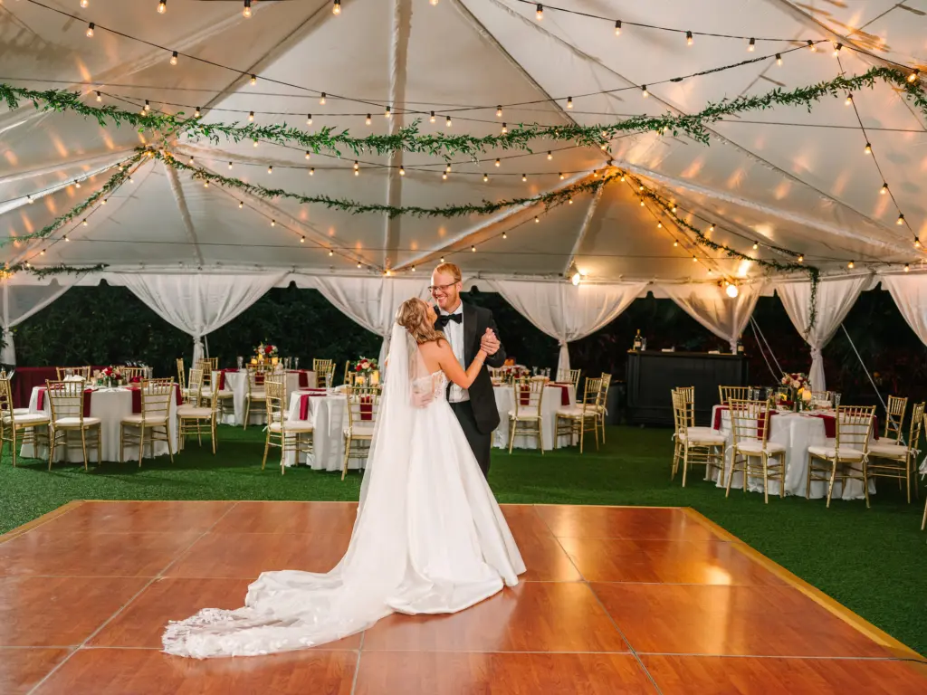 Bride and Groom Private Last Dance Wedding Portrait | Tented Red and White Christmas Inspired Wedding Reception Inspiration | Tampa Bay Planner WilderMind Events | DJ Grant Hemond and Associates | Downtown St. Petersburg Florida Event Venue Sunken Gardens