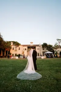 Bride and Groom Overlooking Outdoor Wedding Reception | Sarasota Private Mansion Venue Powel Crosley Estate