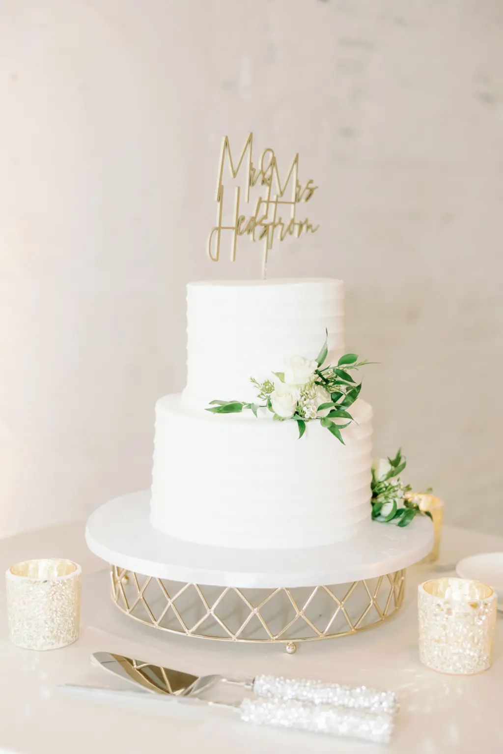Classic Minimalist Two Tier White Wedding Cake with Greenery and White Floral Detailing and Gold Laser Cut Wedding Topper Ideas