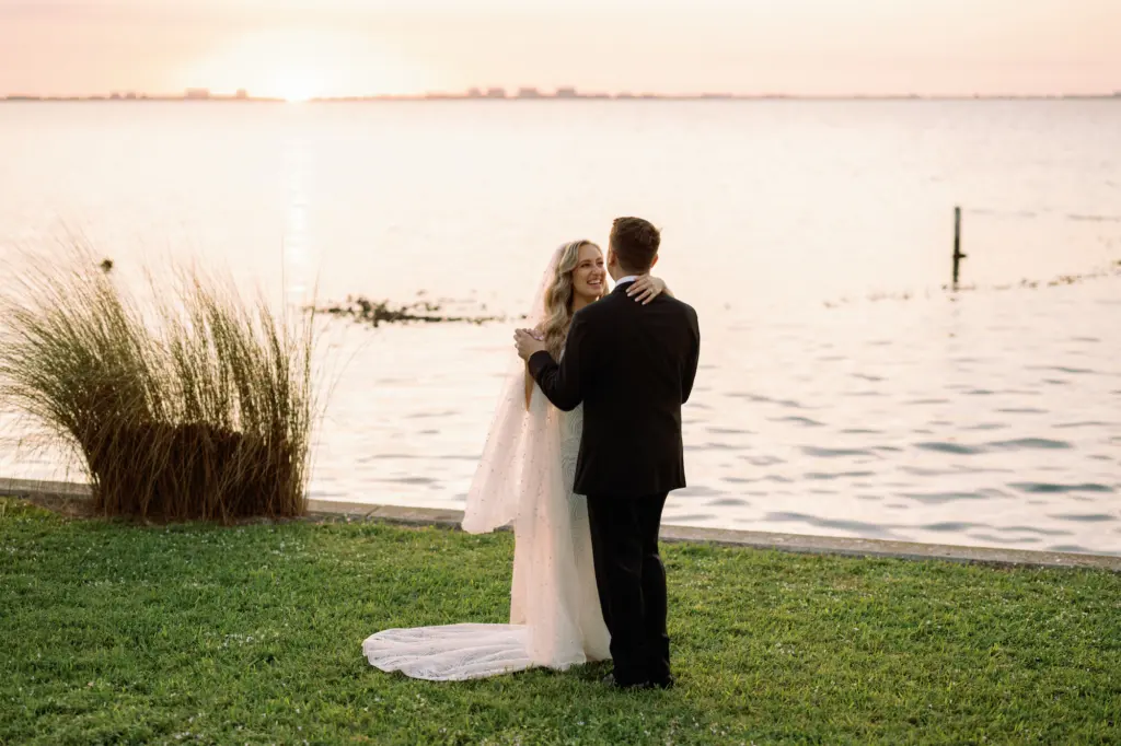 Bride and Groom Dancing by the Water Sunset Wedding Portrait | Waterfront Sarasota Private Mansion Venue Powel Crosley Estate