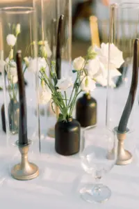 Modern Minimalist Black Bud Vases with Taper Candles, White Flowers, and Hurricane Glass Centerpieces | Outdoor Wedding Reception Tablescape Inspiration