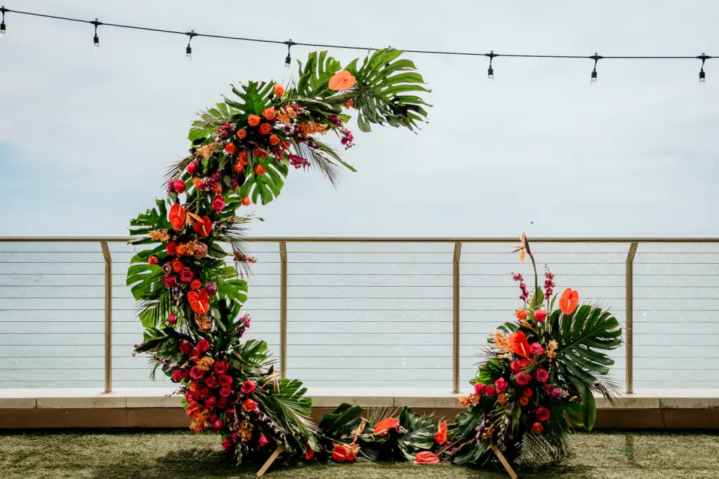 Tropical Semi Circle Arch with Monstera Leaves and Bright Tropical Florals | Wedding Ceremony Decor Inspiration | Clearwater Florist Save the Date Florida | Planner Elegant Affairs by Design
