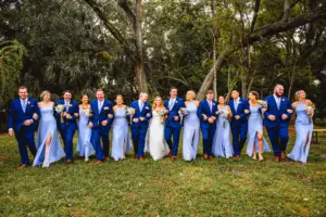 Bride and Groom with Bridal Party Wedding Portrait | Mismatched Periwinkle Blue Azazie Bridesmaids Dress Ideas | Navy Suit Inspiration