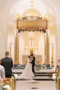 Bride and Groom First Kiss Church Wedding Portrait | Classic Catholic Church Wedding Ceremony | St Pete Saint Mary Our Lady of Grace