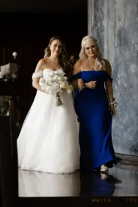 Bride and Mother Walking Down Wedding Aisle