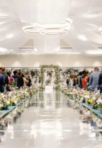 Colorful Indian Fusion Wedding Ceremony with White Drapery, Greenery Garland Backdrop | Spring Flower Aisle Decor with Mirrored Aisle Ideas | Tampa Venue Hilton Clearwater Beach | Florist Lemon Drops Weddings & Events