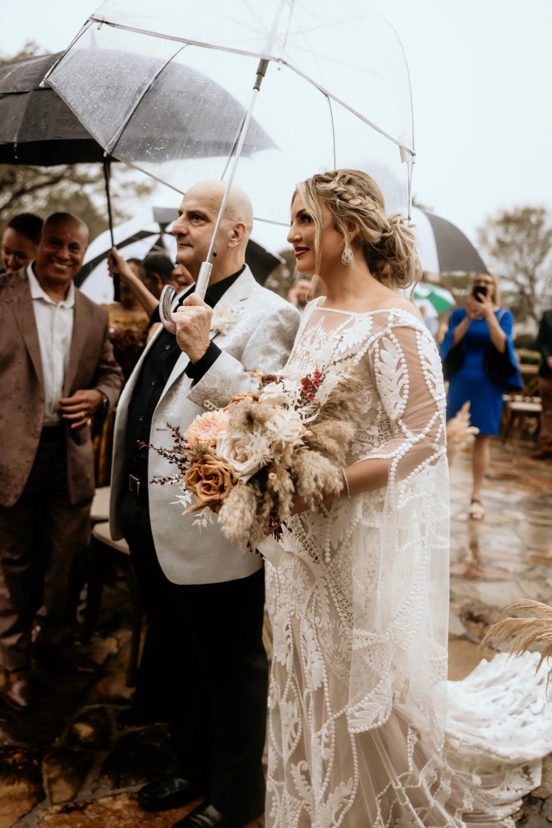 Bride and Father Walking Down Wedding Aisle with Clear Umbrella