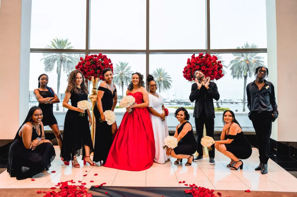 Bridal Party Portrait Black and Red Gatsby 1920s Inspiration | Bridesmaids and Bridesmen in Black Attire with White Rose Bouquets
