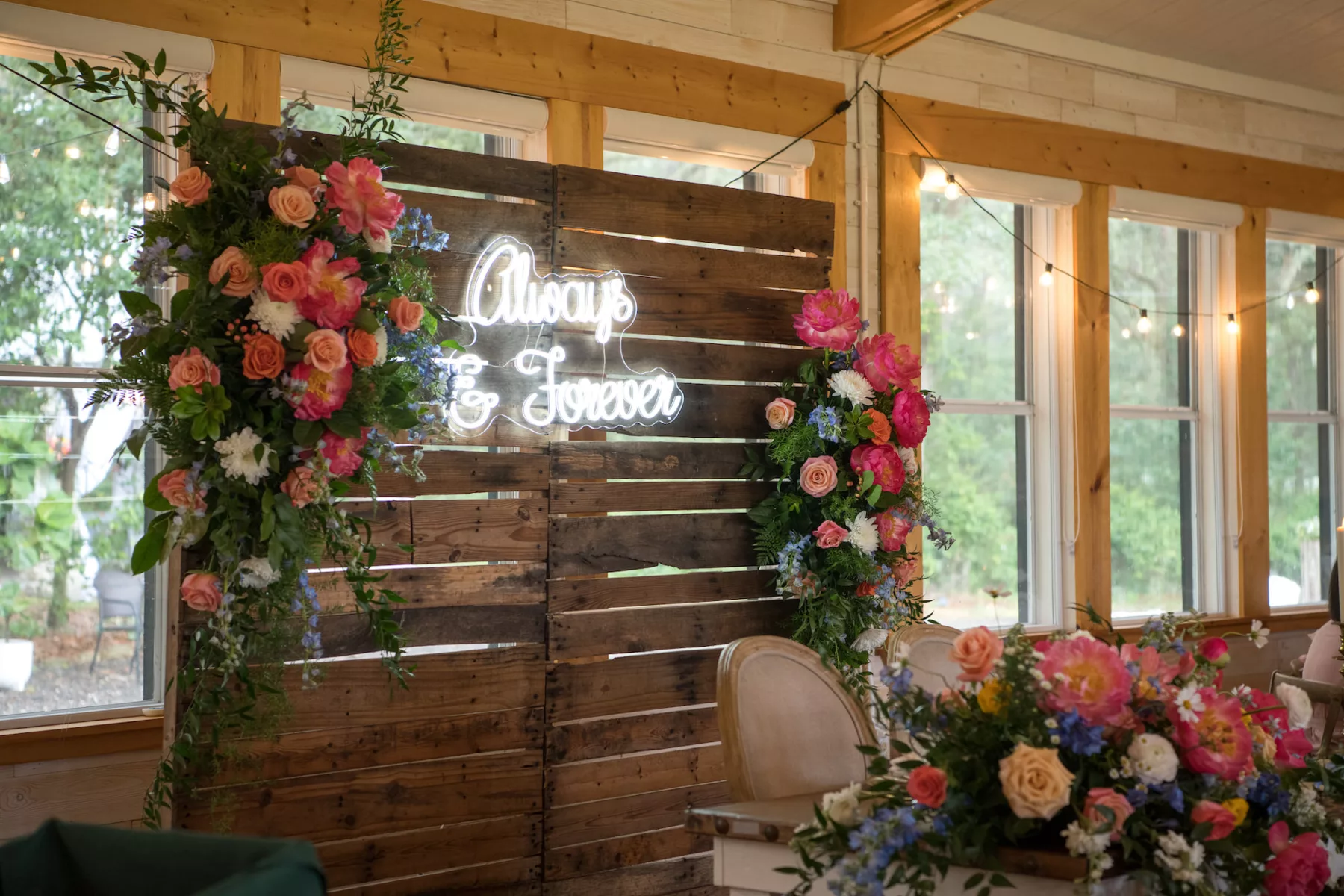 Pallet Wood Wedding Reception Sweetheart Table Backdrop Decor with Always and Forever Neon Sign Inspiration | Pink Peony, Orange Roses, White Chrysanthemums, Blue Delphinium Floral Arrangement Ideas