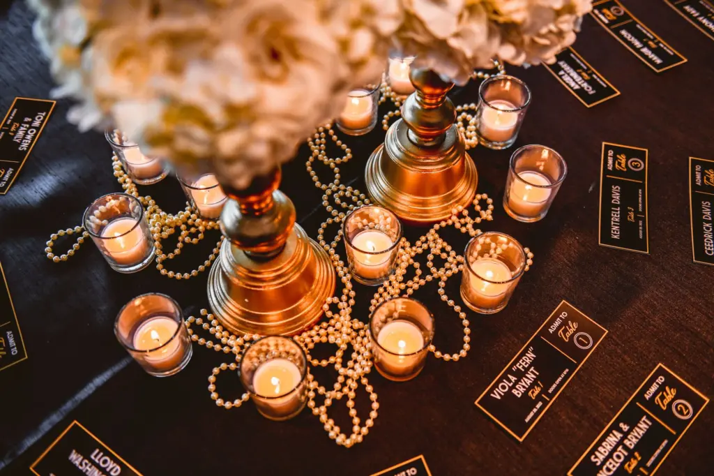 Black and Red Gatsby 1920 Theater Wedding Decor Ideas | Candles, Pearl Beads and Gold Candelabra Floral Centerpiece | Theatre Ticket Escort Card Seating Chart Display