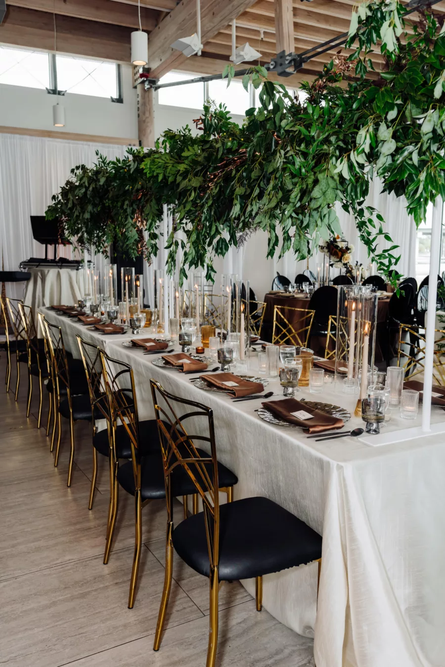 Modern Black and Bronze Wedding Reception Decor Inspiration | Cascading Greenery Over Feasting Table Ideas | Tampa Bay Kate Ryan Event Rentals | A Chair Affair