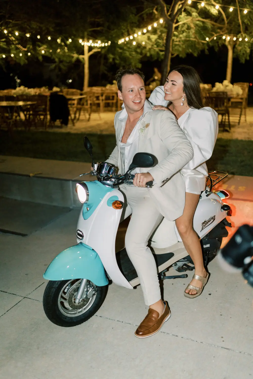 Bride and Groom on Getaway Vespa Scooter after Wedding Reception