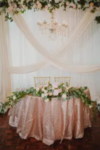Blush Sweetheart Table with Sequin Table Cloth Inspiration and Cascading Greenery Garland with White and Pink Roses | Romantic Wedding Reception Ideas