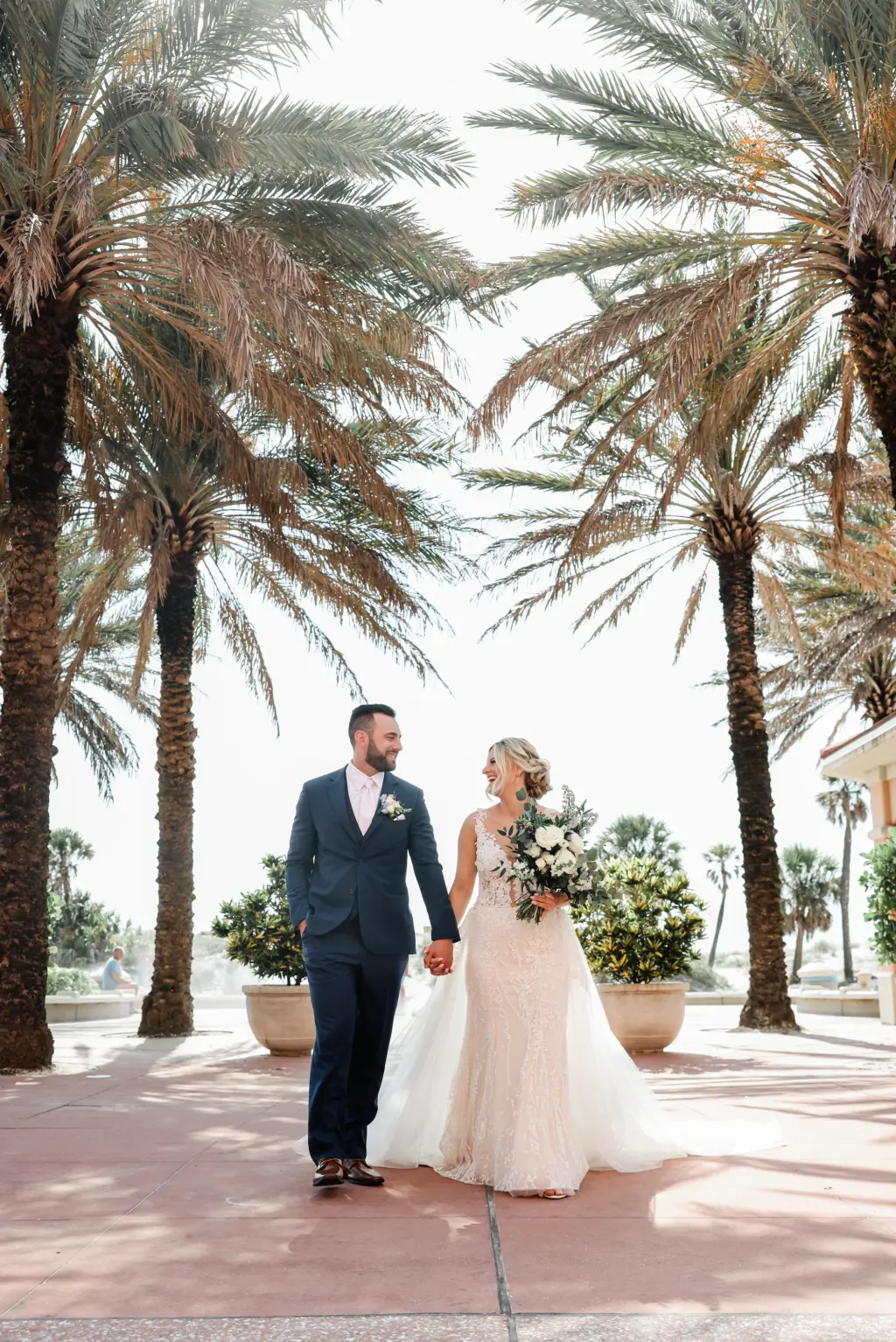 Bride and Groom Walking Under Clearwater Beach Palm Trees | Venue Hyatt Regency Clearwater Beach