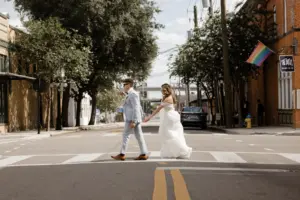 Bride and Groom Walking Across the Street of Ybor Wedding Portrait | Tampa Bay Photographer Garry and Stacy Photography Co. | Planner Coastal Coordinating