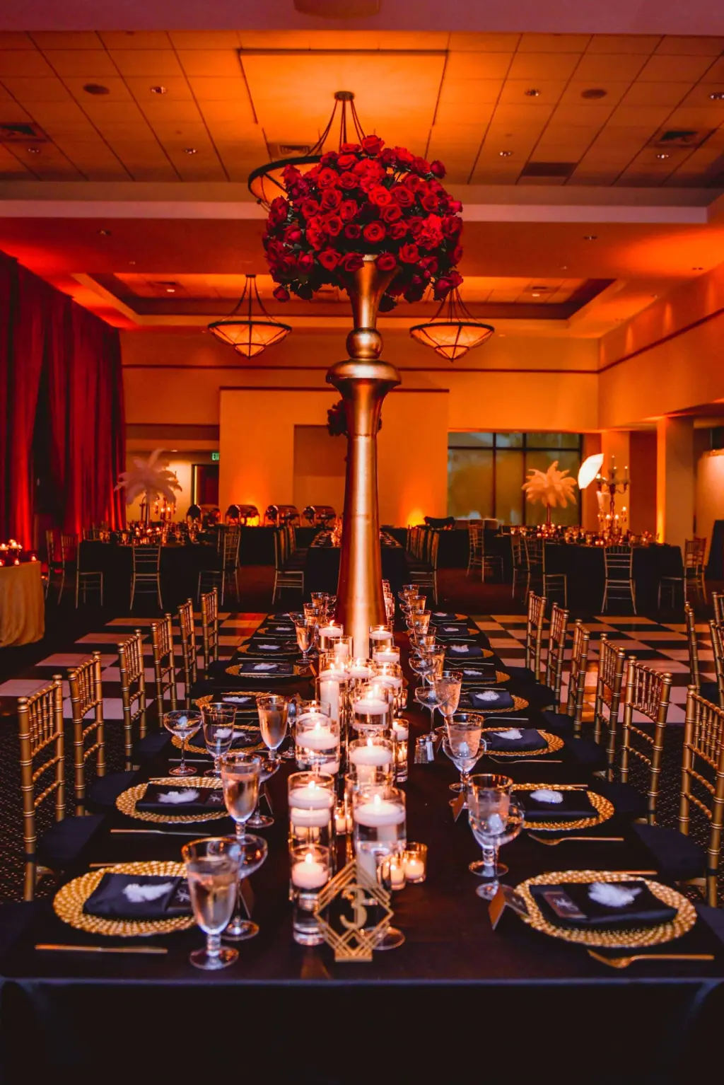 Gold Vintage Centerpiece with Red Roses and Floating Candles Tablescape Wedding Reception Inspiration | Gold Chiavari Chairs and Chargers from Tampa Event Rental Company A Chair Affair