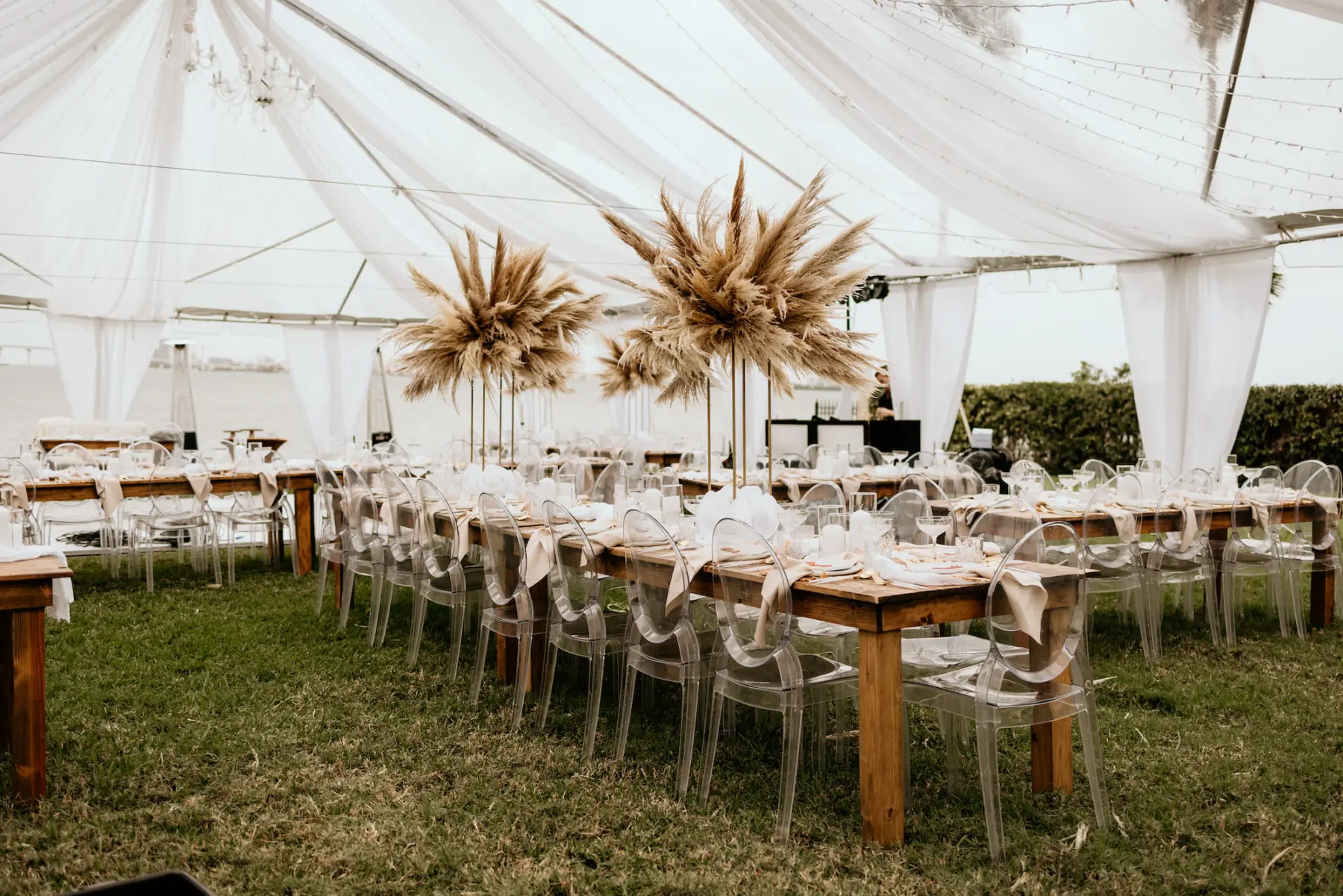 Clear Tented Boho Wedding Reception with Long Feasting Tables and Ghost Chairs | Pampas Grass Centerpiece Ideas