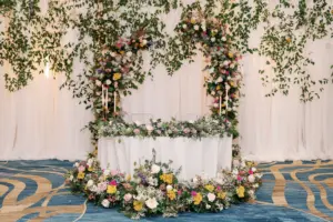 Whimsical Sweetheart Table with Colorful Backdrop | Pink Roses, Baby's Breath, and Greenery Table Garland Ideas | Clearwater Florist Lemon Drops Weddings and Events