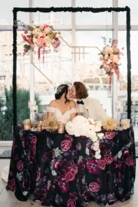 Black and Pink Floral Satin Tablecloth for Wedding Reception Sweetheart Table with Pink Roses, Amaranthus, Purple Hydrangea Hanging Backdrop Ideas | Tampa Planner Unique Weddings and Events