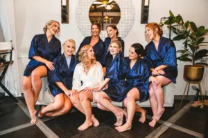 Bride and Bridesmaids Getting Ready | Wedding Hair and Makeup Ideas | Matching Navy Blue Satin Robes