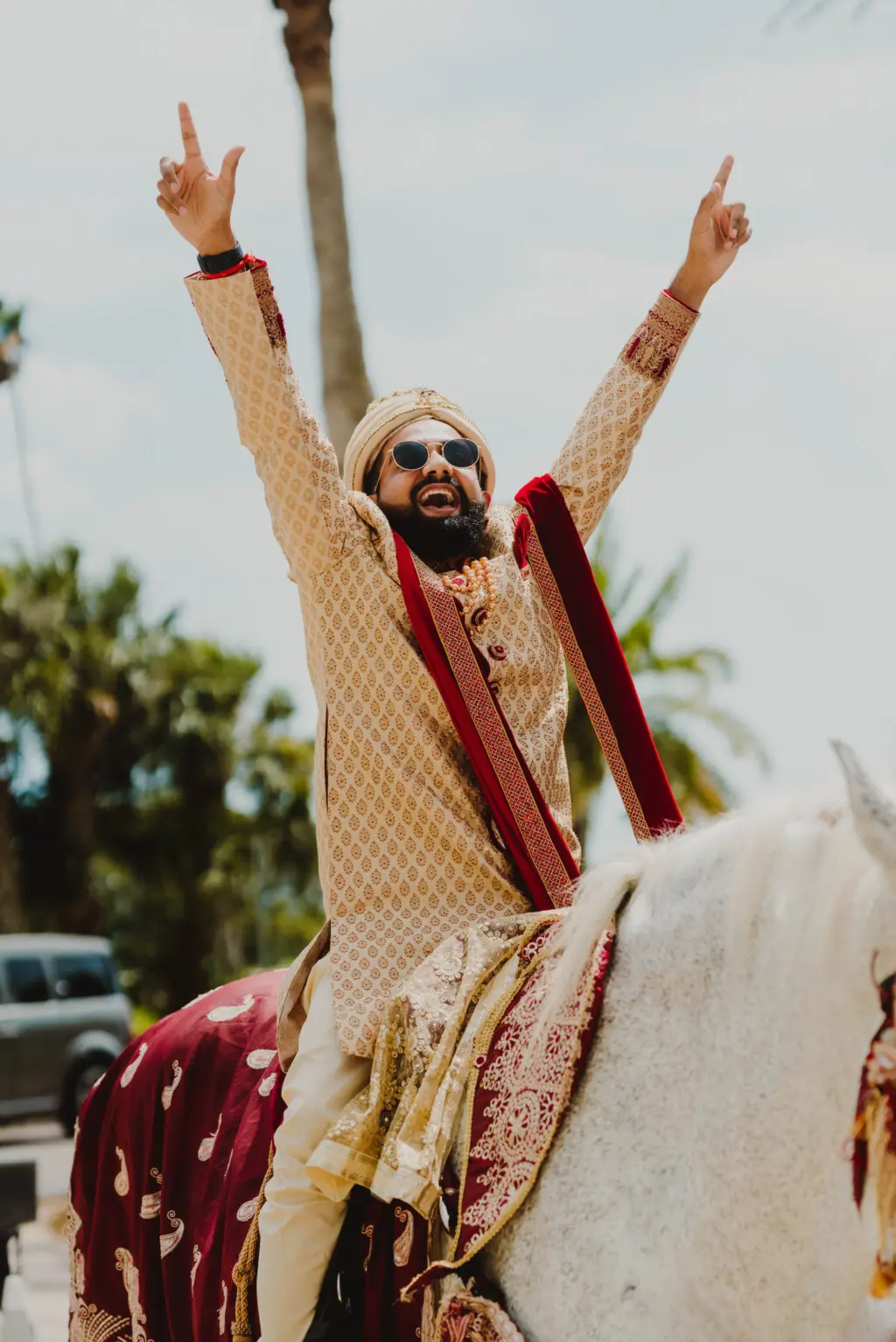 Groom's Red and Gold Sherwani with Stole Riding Horse for Indian Baraat Wedding Portrait | Tampa Photographer and Videographer Mars and The Moon Films
