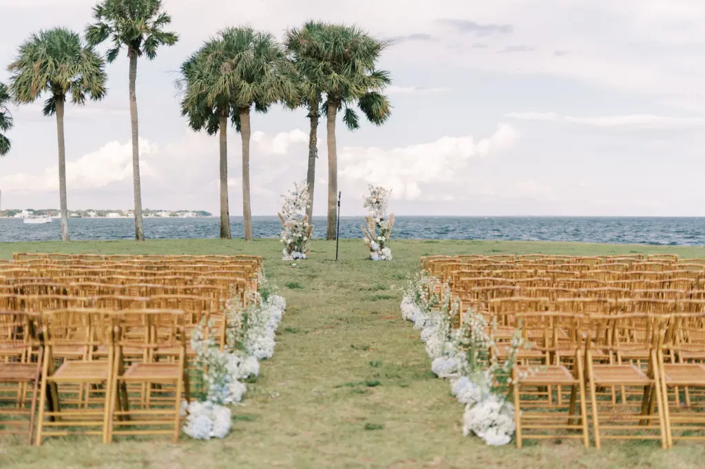 Waterfront Coastal Boho Wedding Ceremony Decor Ideas | Bamboo Rattan Chairs with Baby's Breath, Blue Hydrangeas, and Tall White Wildflowers | St Pete Outdoor Event Venue St. Pete Pier