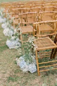 Elegant Boho Coastal Wedding Ceremony Decor Inspiration | Bamboo Rattan Chairs with Baby's Breath, Blue Hydrangeas, and Tall White Wildflowers Aisle Arrangements