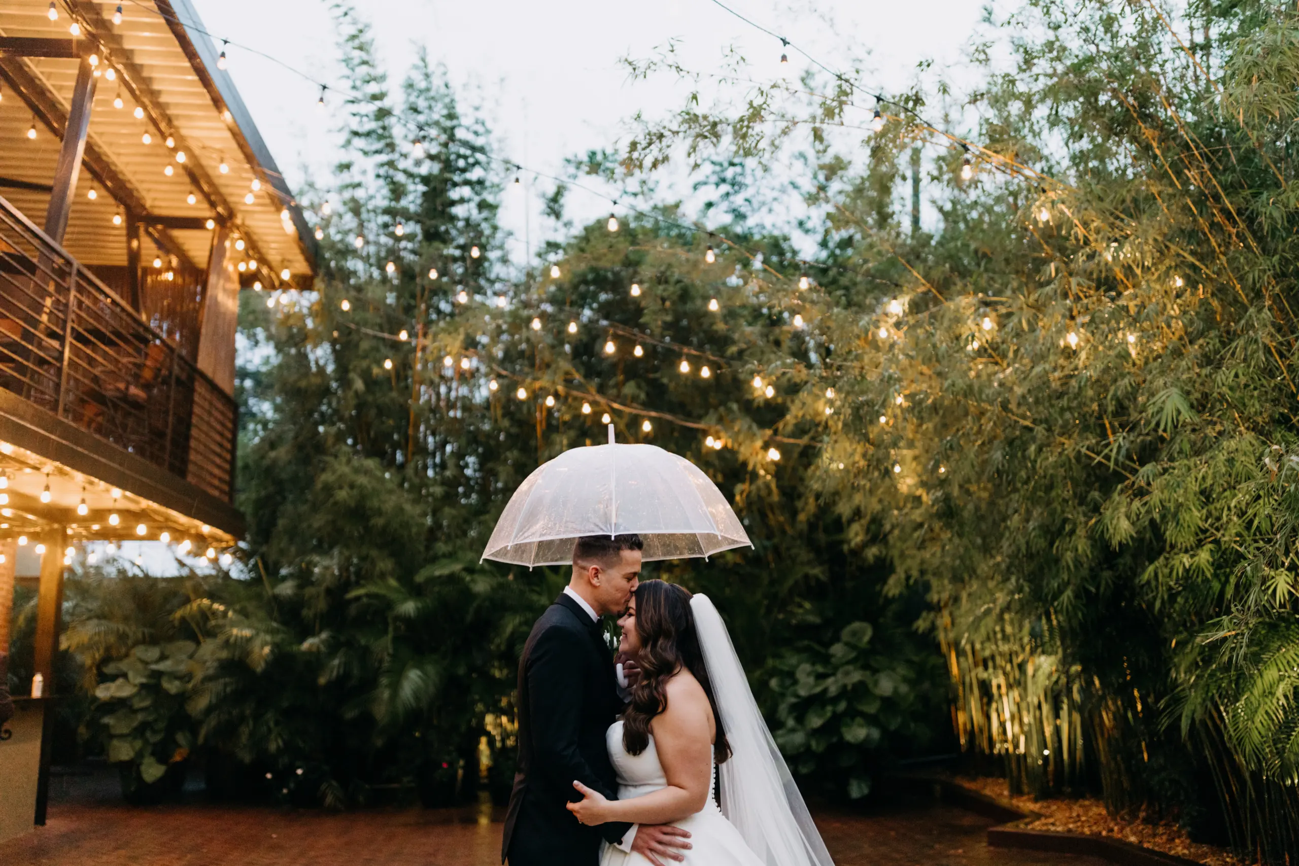 Bride and Groom Bamboo Courtyard Wedding Portrait with Umbrella | Justin Alexander Ballgown Dress | Photographer Amber McWhorter Photography | Downtown St Pete Venue NOVA 535