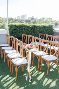 Wooden Crossback Chairs with Peach and Orange Roses, and Greenery Wedding Ceremony Chair and Aisle Decor Inspiration