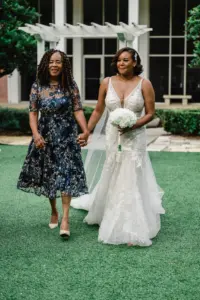 Bride and Mother Walking Down Wedding Aisle | All Who Wander Ivory Wedding Dress Gown