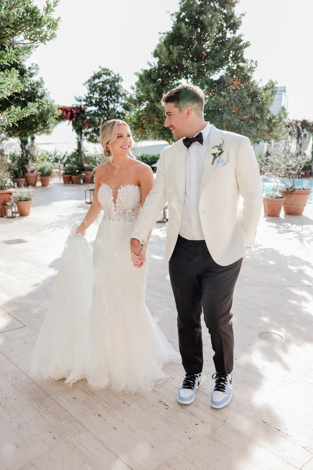 Bride and Groom First Look Wedding Portrait | Black and White Tuxedo with Light Blue Nike Dunk Retro Shoe | Strapless White Floral Applique Pronovias Mermaid Wedding Dress Inspiration | Tampa Bay Photographer Lifelong Photography