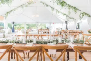 White Tented Boho Wedding Reception with Hanging Eucalyptus | Farmhouse Tables and Wooden Crossback Chairs | Tampa Bay Kate Ryan Event Rentals | Venue The Epicurean