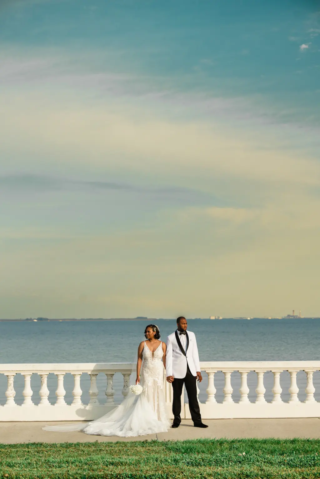 Bride and Groom Sunset on Bayshore Wedding Portrait | Tampa Bay Photographer Iyrus Weddings | All Who Wander Wedding Gown Dress