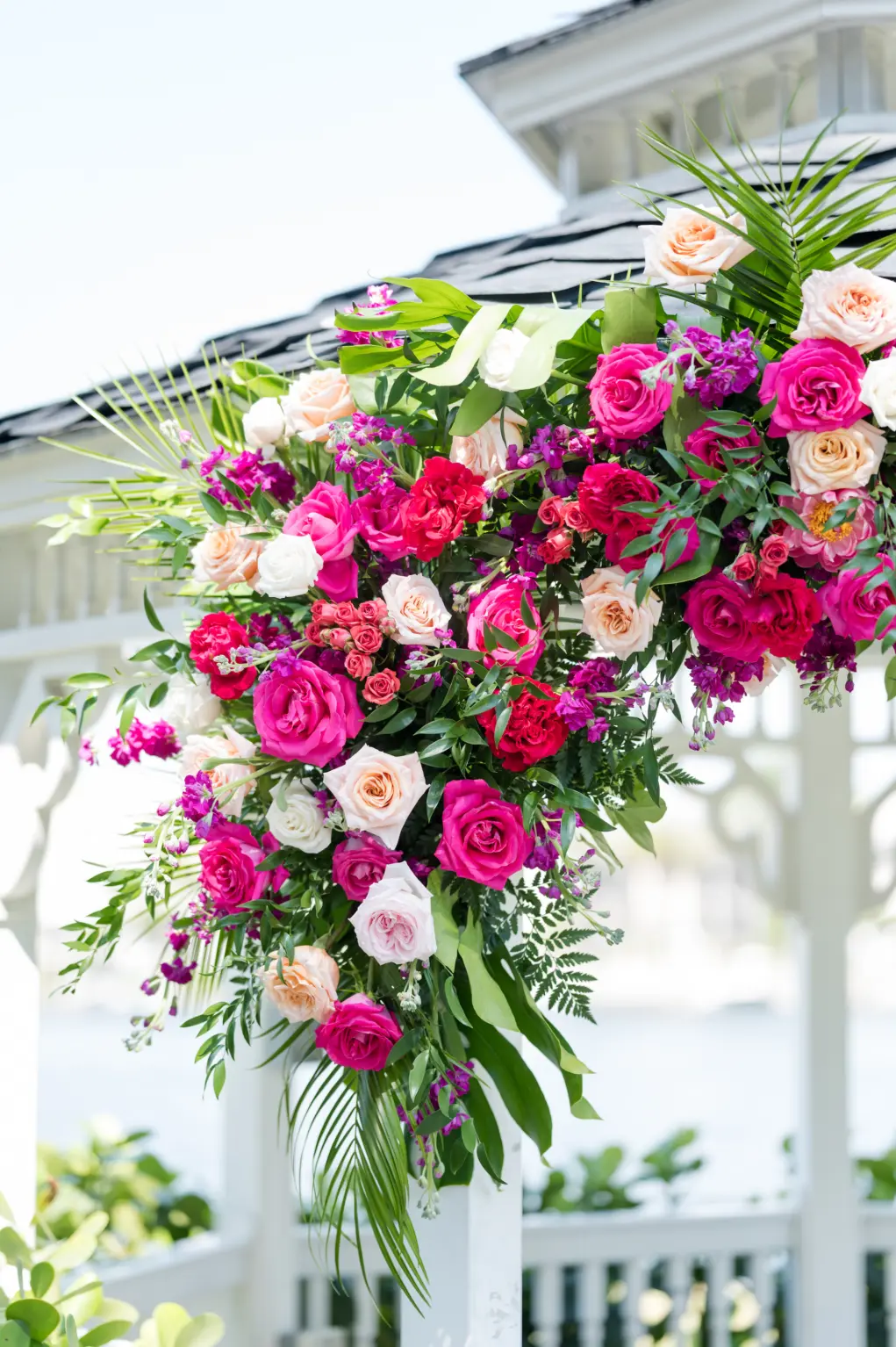 Tropical Floral Ideas for Wedding Ceremony Gazebo Arch | Red, Pink, Orange, and White Roses with Greenery