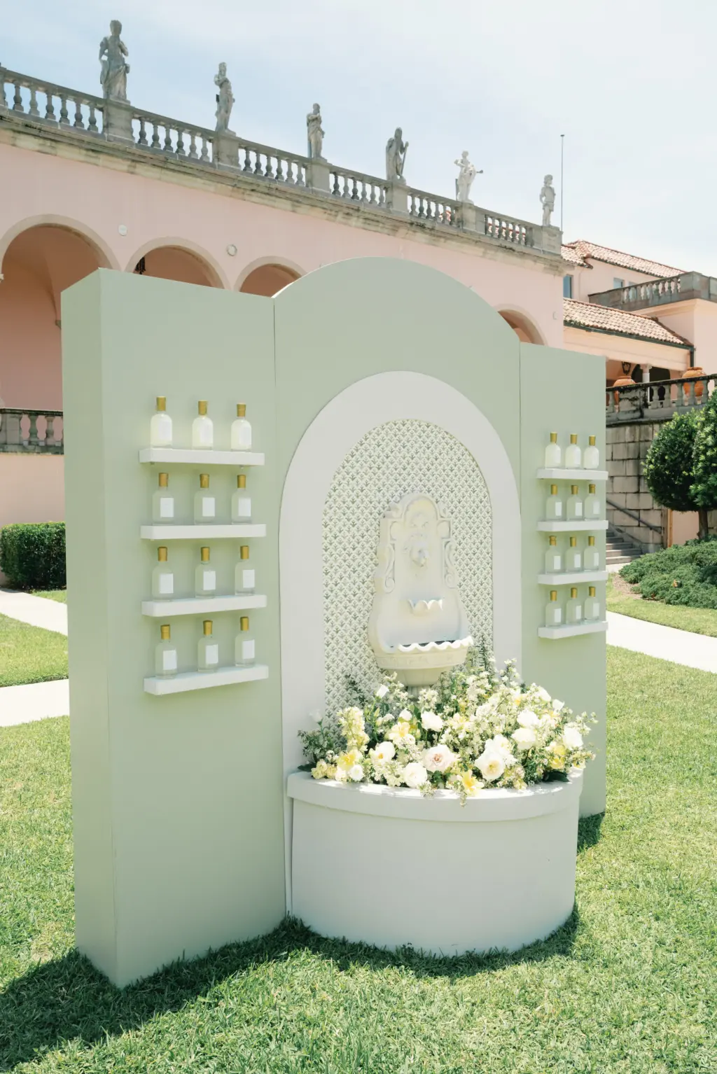 Unique Italian Fountain Table Seating Chart Inspiration | Custom Labels on Limoncello Bottles for Wedding Reception Place Cards | Summer Decor Ideas