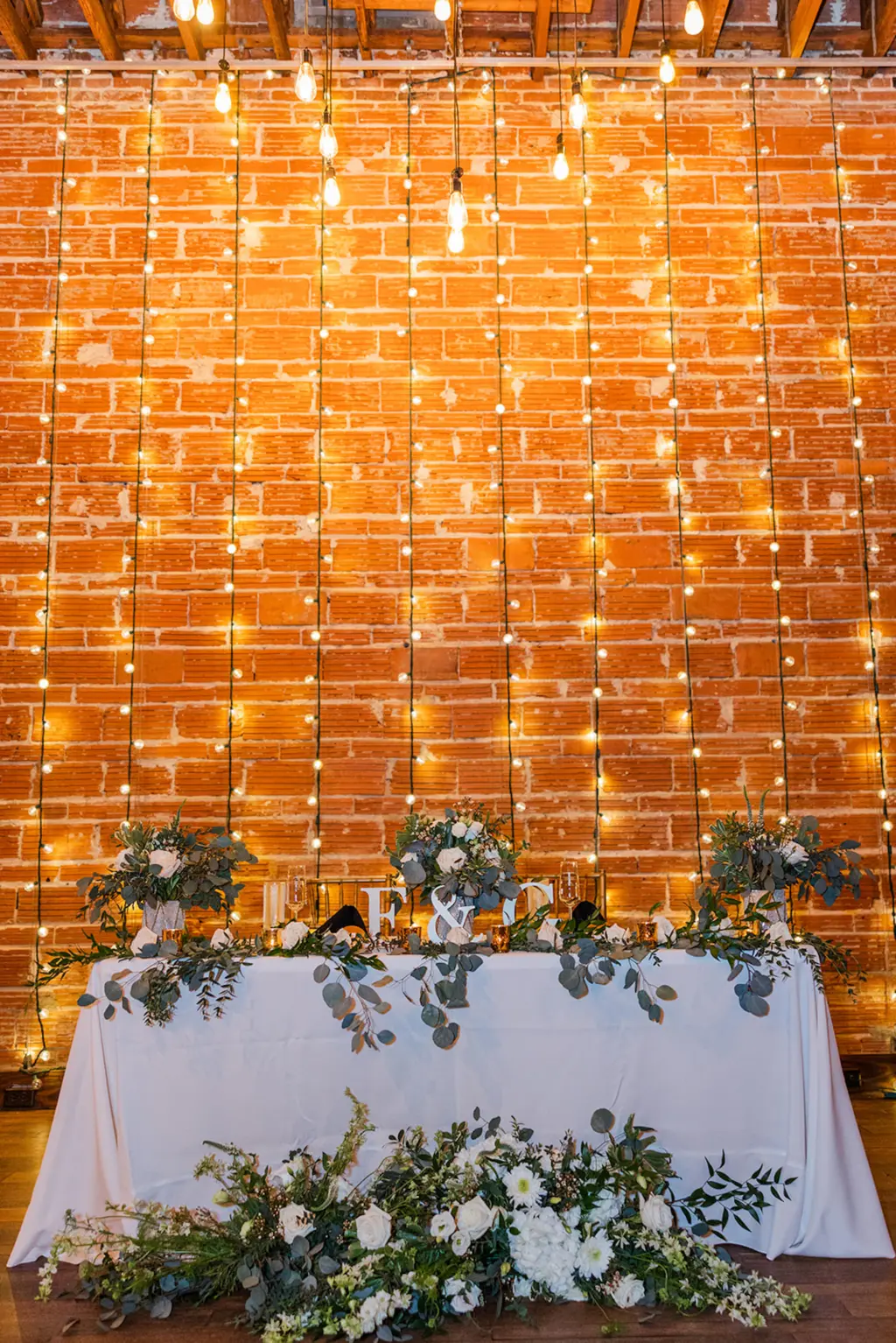 Elegant String Light Backdrop | Eucalyptus Greenery Garland with Gold Mercury Votives | Wedding Reception Sweetheart Table Decor Inspiration