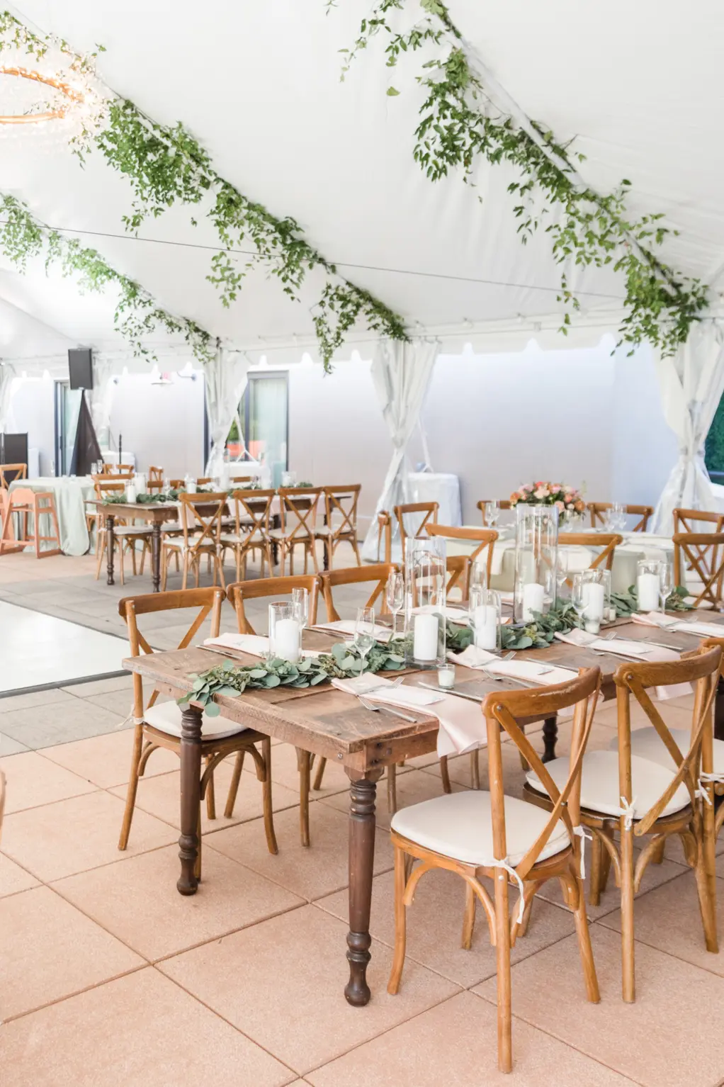 White Tented Boho Wedding Reception with Hanging Eucalyptus | Farmhouse Tables and Wooden Crossback Chairs | Tampa Bay Kate Ryan Event Rentals