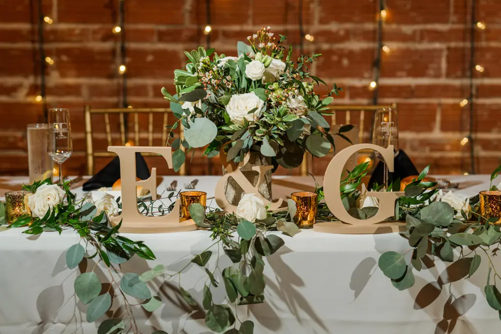 Elegant Eucalyptus Greenery Garland with Gold Mercury Votives | Wedding Reception Sweetheart Table Decor Inspiration | Champagne Bride and Groom Monogram Tabletop Signs