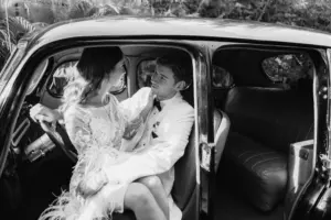 Bride and Groom Black and White Vintage Classic Getaway Car Wedding Portrait | Tampa Bay Photographer McNeile Photography | St Pete Car Rental Service Classically Ever After | Videographer Sabrina Autumn Photography