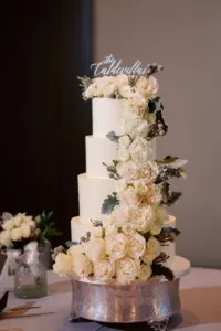 White Round Four-Tiered Buttercream Wedding Cake with White Cascading Garden Rose Accents | Tampa Bay Cake Bakery The Artistic Whisk