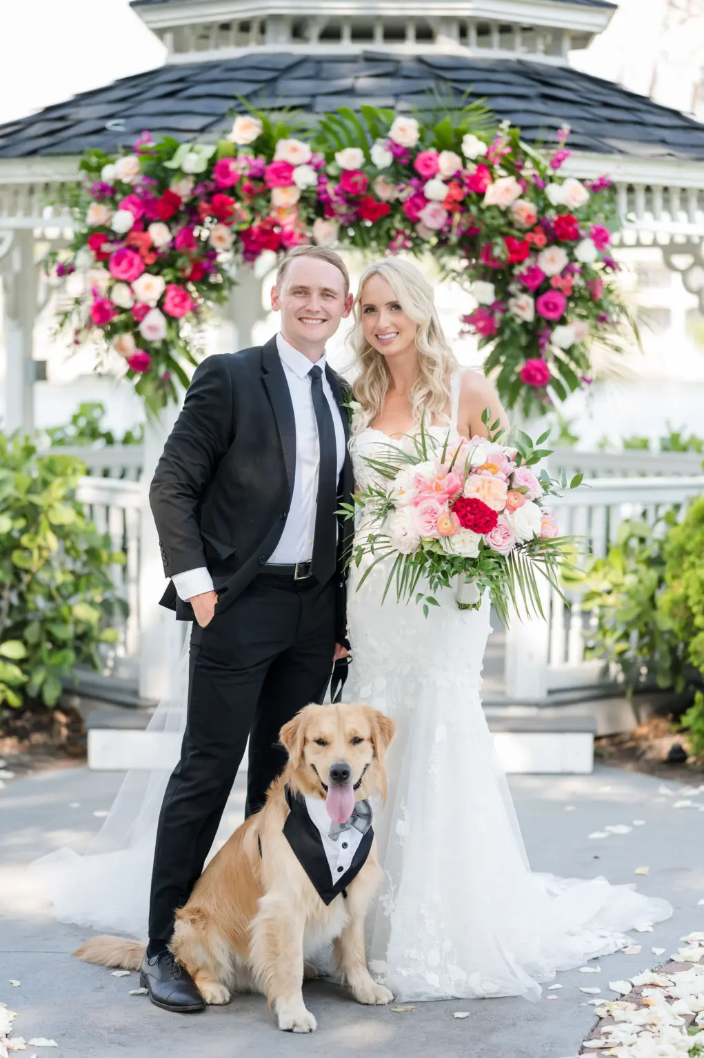 Bride and Groom with Dog Wearing Wedding Tuxedo Bandana | Tropical Pink and White Wedding Ceremony Gazebo Altar Decor Inspiration