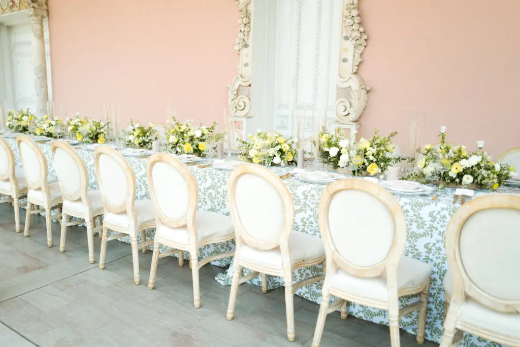 Intimate Italian Outdoor Wedding Reception | Long Feasting Table Inspiration with Damask Table Linen and Louis Chairs | Yellow and White Floral Centerpieces