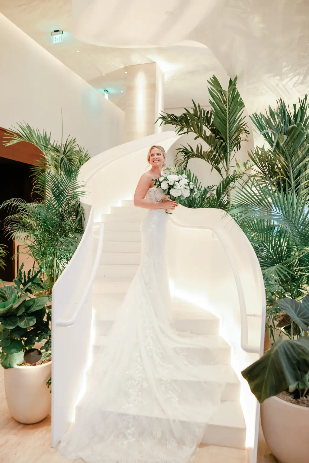 Strapless White Floral Applique Pronovias Mermaid Wedding Dress with Cathedral Length Train | Downtown Event Venue The Edition Hotel Tampa Water Street Lobby Staircase | Bridal Portrait Inspiration