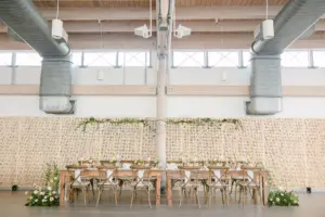 Elegant Garden Wedding Reception Decor Inspiration | Rustic Long Wooden Feasting Table With French Country Cross Back Chairs | Floating Candles | Tall Flower Stand Centerpieces with Greenery Ideas | Downtown Riverwalk Event Venue Tampa River Center