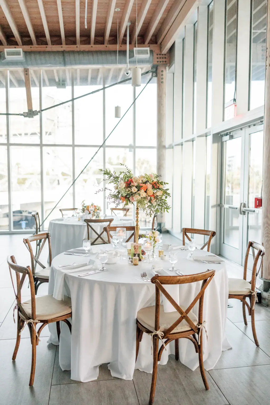 Elegant Garden Wedding Reception Decor Inspiration | Rustic Wooden Crossback Chairs | Floating Candles | Tall Flower Stand Centerpieces with Peach Orange Roses and Greenery Ideas | Tampa Bay Caterer Elite Events and Catering